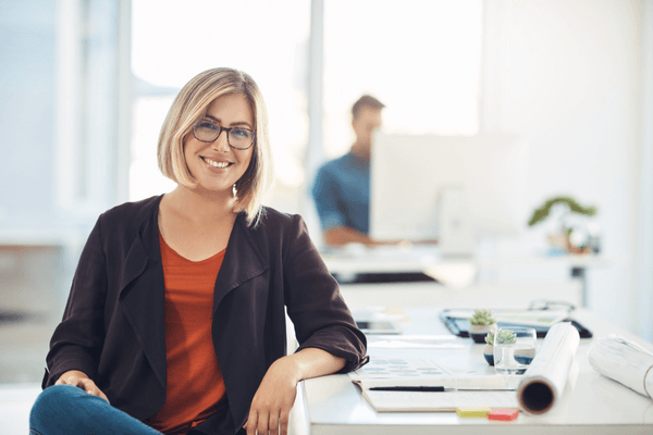 Home energy advisor smiling at her desk 